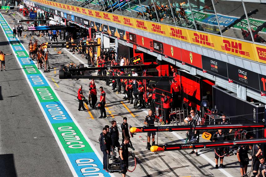 Formula 1 cars and crew in the pit lane